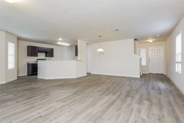 a view of a kitchen with a sink and a refrigerator