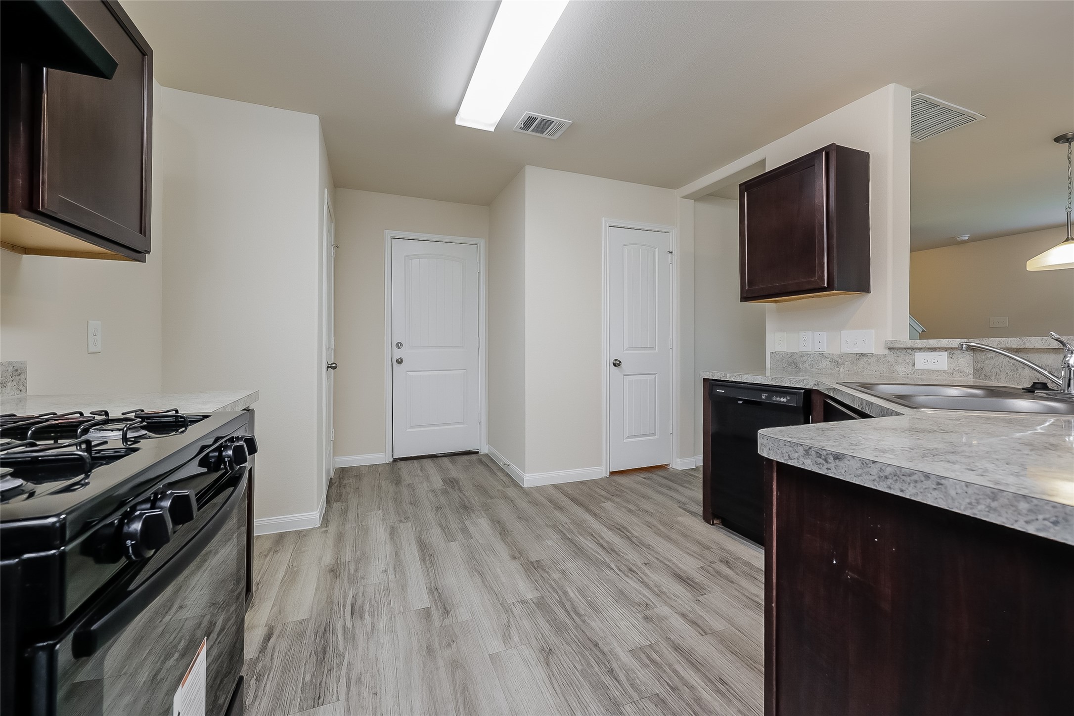 4114 Farmers Pass Road Houston, TX 77014 - Photo 6 of 15 a kitchen with a stove and a wooden floor