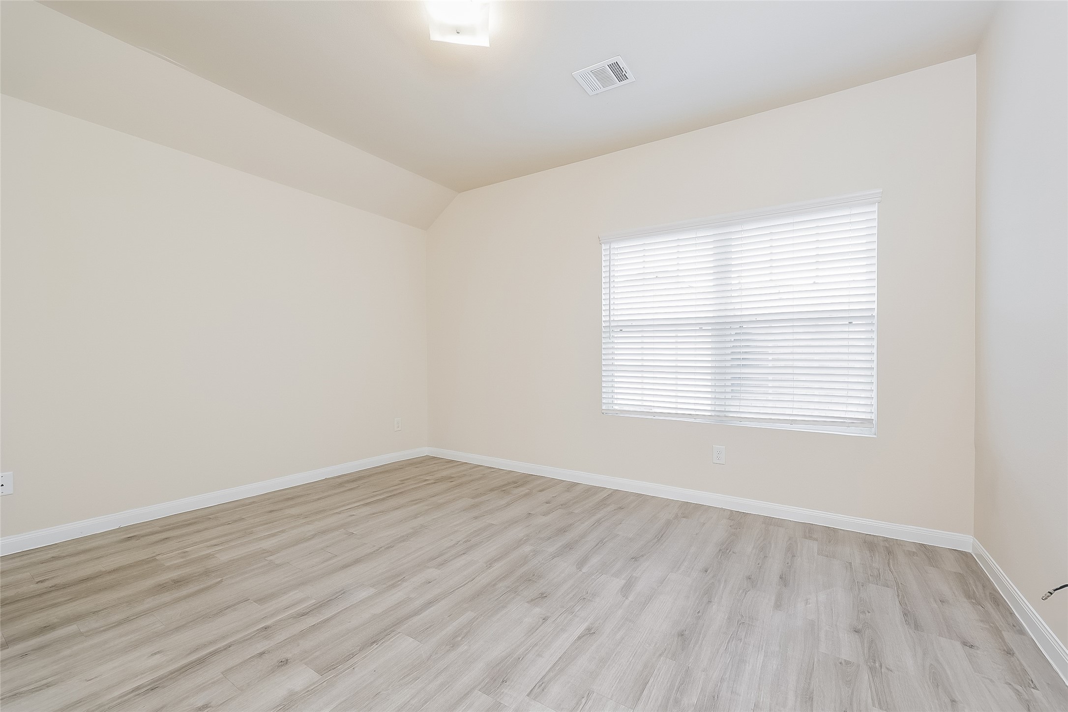 4114 Farmers Pass Road Houston, TX 77014 - Photo 10 of 15 an empty room with wooden floor and windows