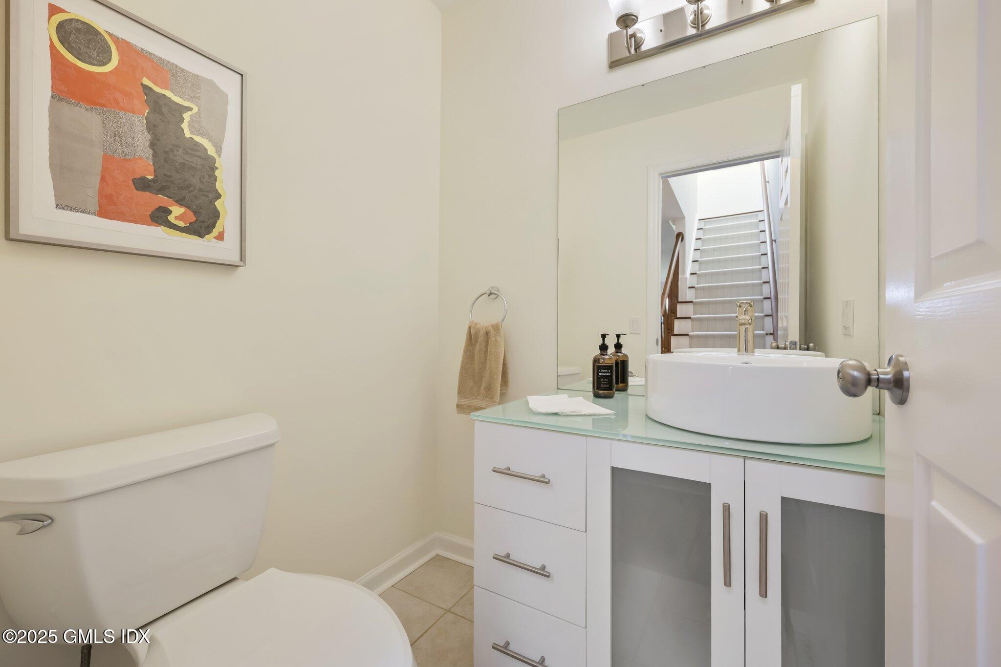 172 Field Point Road, Unit 9 Greenwich, CT 06830 - Photo 12 of 20 a bathroom with a toilet sink and mirror