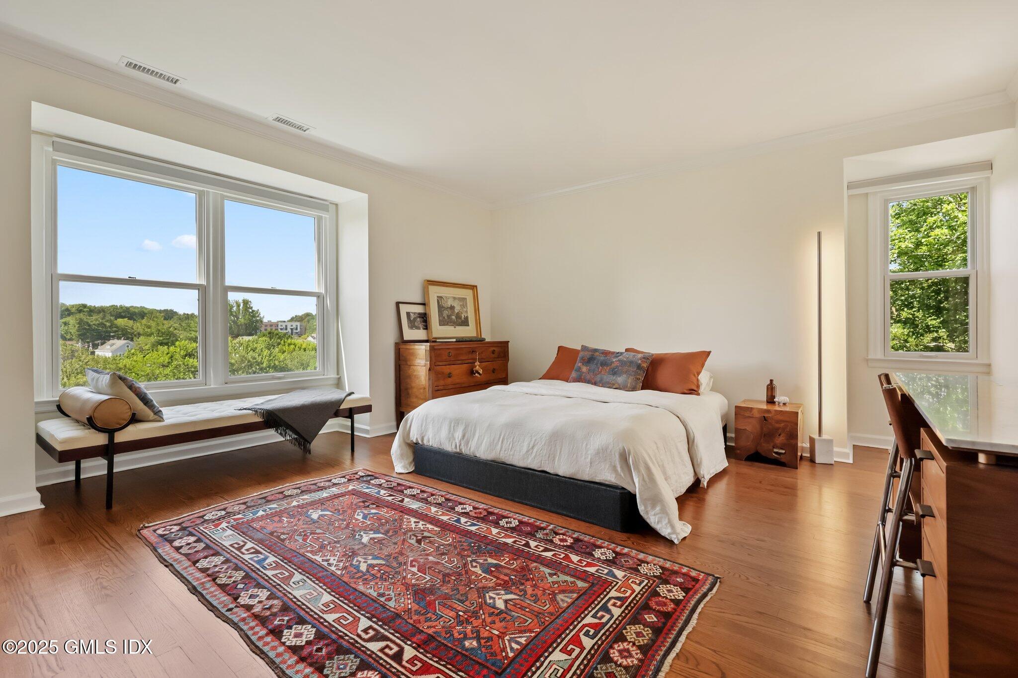 172 Field Point Road, Unit 9 Greenwich, CT 06830 - Photo 14 of 20 a bed sitting in a bedroom next to a window