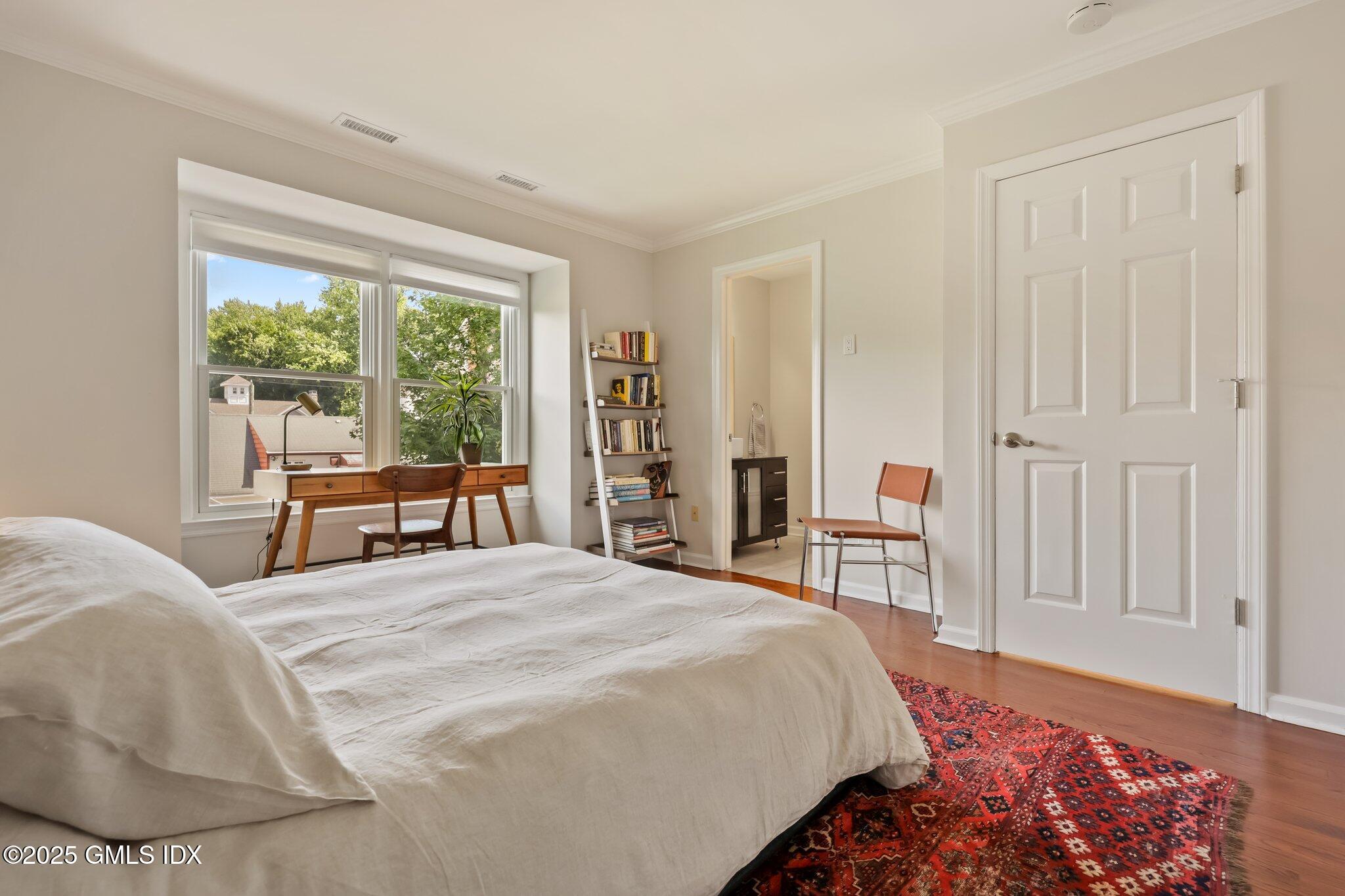 172 Field Point Road, Unit 9 Greenwich, CT 06830 - Photo 17 of 20 a spacious bedroom with a bed and a large window