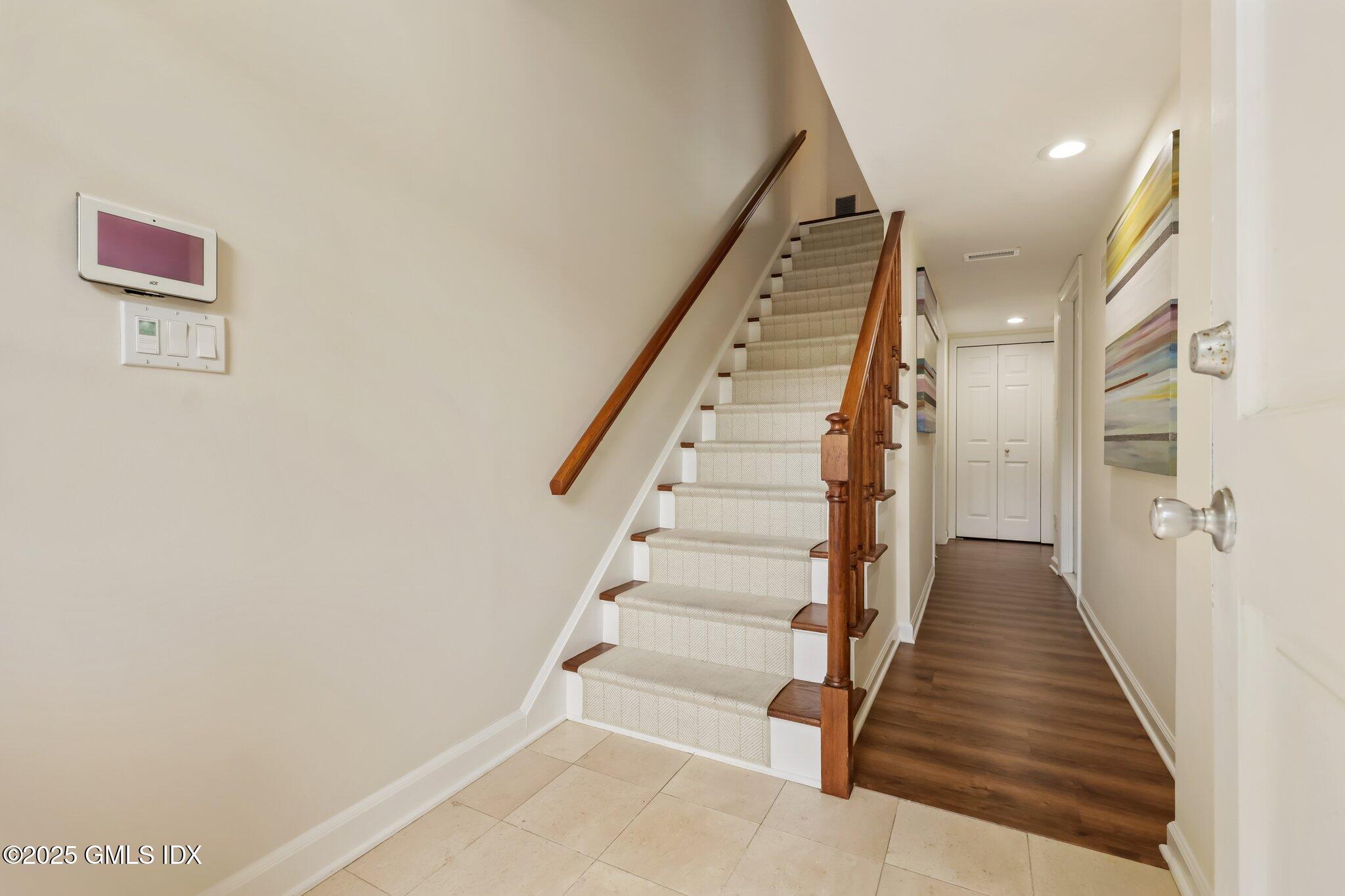 172 Field Point Road, Unit 9 Greenwich, CT 06830 - Photo 2 of 20 a view of staircase with wooden floor and white walls