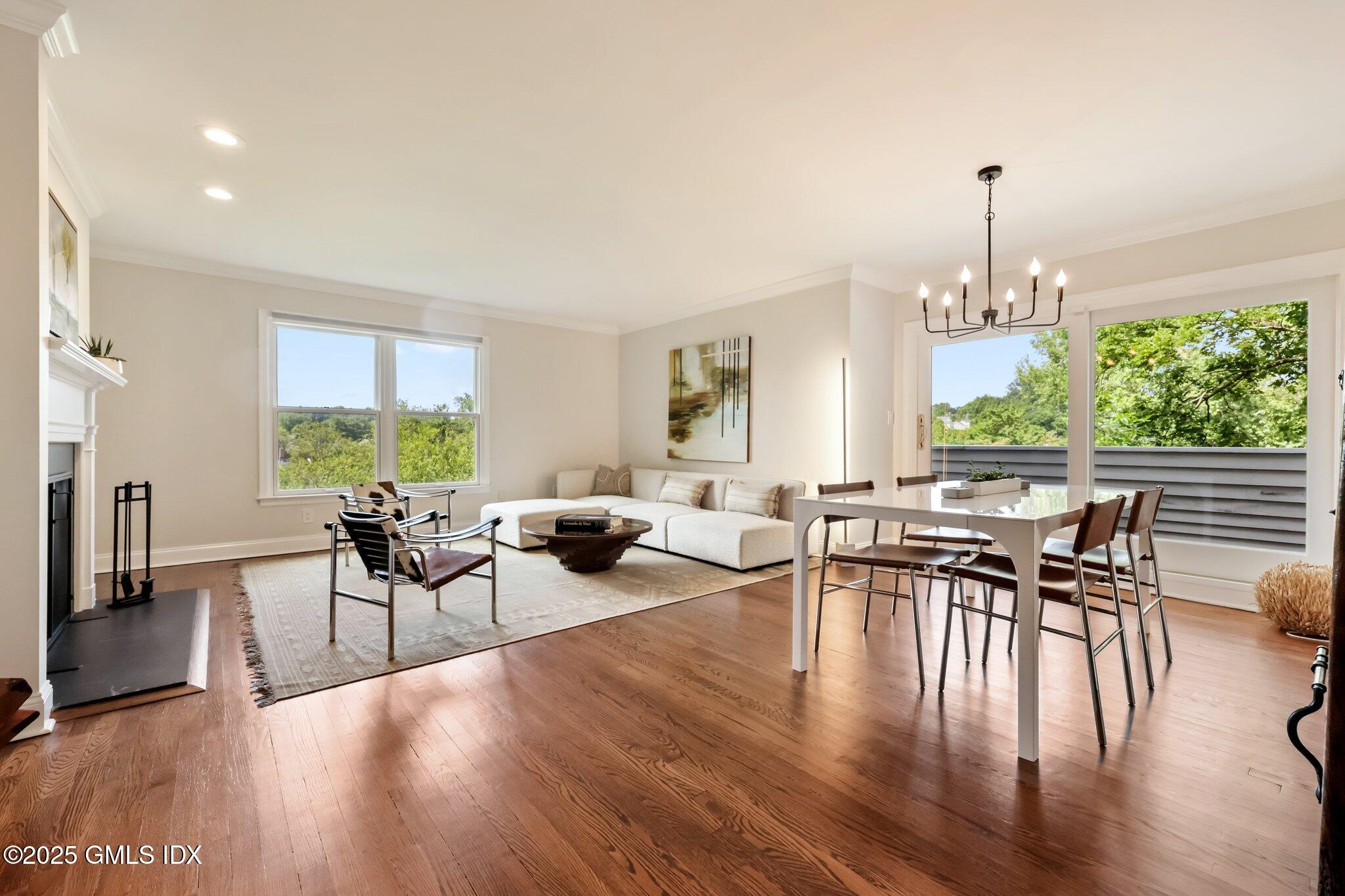 172 Field Point Road, Unit 9 Greenwich, CT 06830 - Photo 3 of 20 a view of a dining room with furniture window and wooden floor