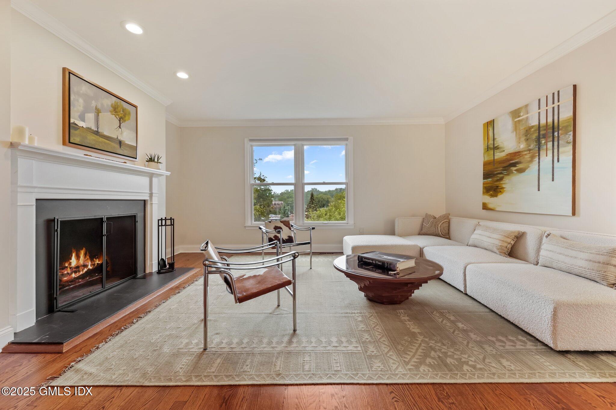172 Field Point Road, Unit 9 Greenwich, CT 06830 - Photo 4 of 20 a living room with furniture and a fireplace