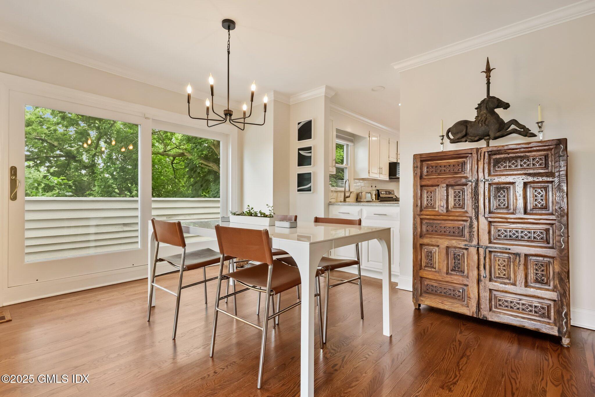 172 Field Point Road, Unit 9 Greenwich, CT 06830 - Photo 6 of 20 a view of a dining room with furniture window and wooden floor