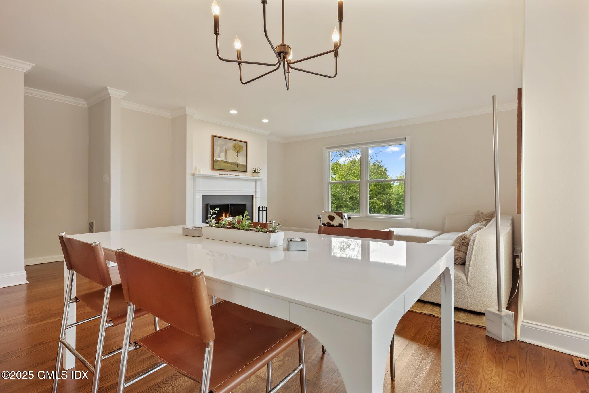 172 Field Point Road, Unit 9 Greenwich, CT 06830 - Photo 7 of 20 a view of a dining room with furniture and wooden floor
