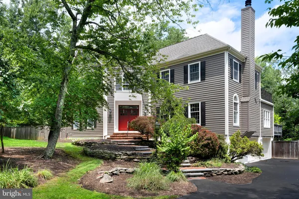 a house that has a tree in front of the house