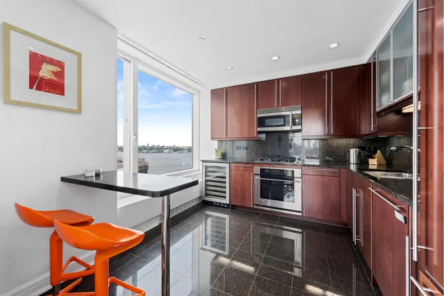 a spacious bedroom with a bed and a large window