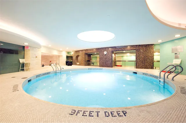 a view of a swimming pool with a dining table chairs