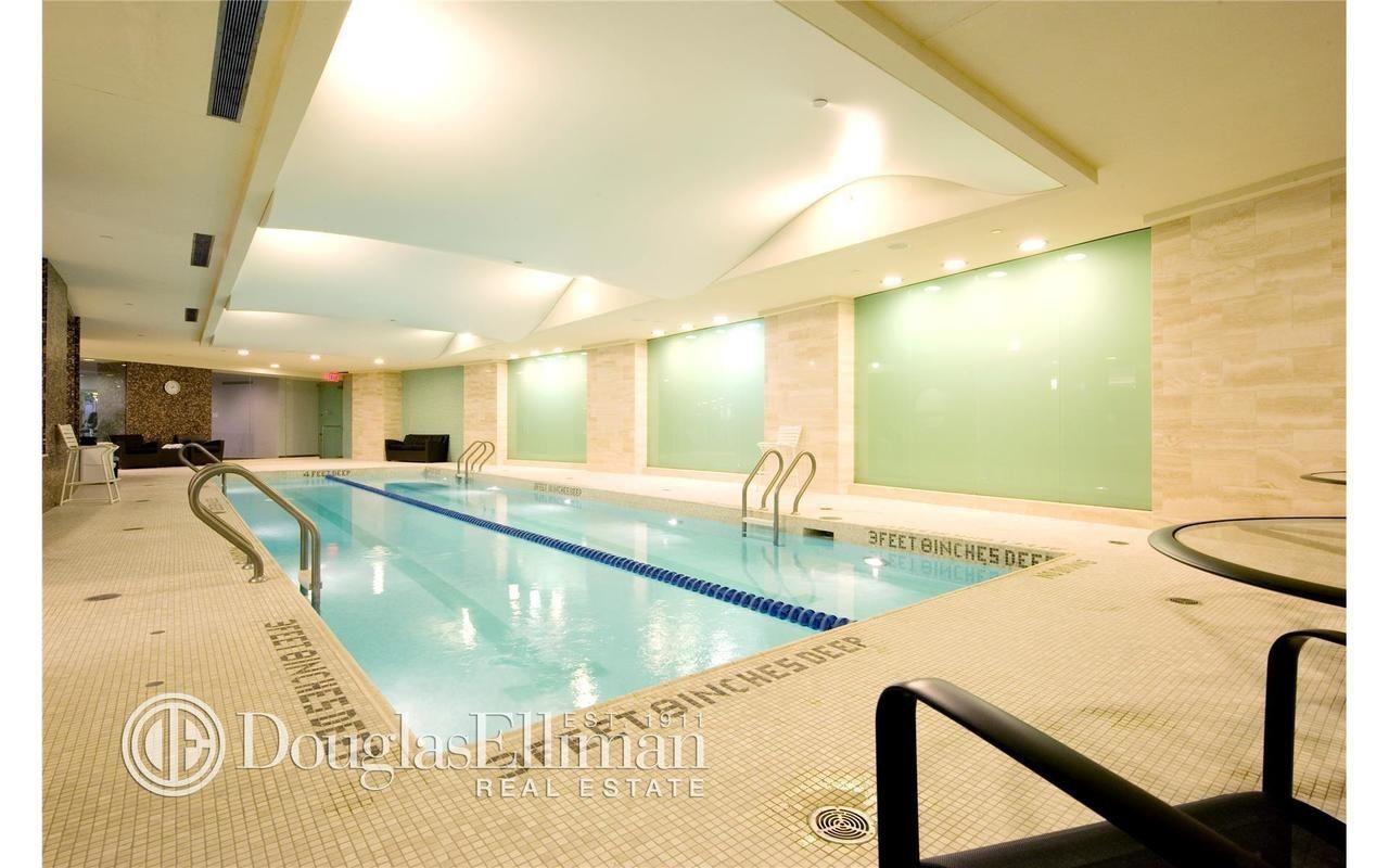 240 Riverside Boulevard, Unit 21C Manhattan, NY 10069 - Photo 26 of 32 a view of a kitchen island a sink and a table