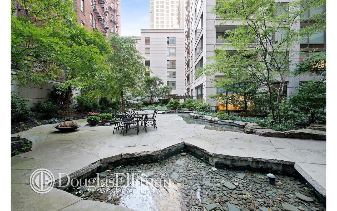 240 Riverside Boulevard, Unit 21C Manhattan, NY 10069 - Photo 29 of 32 a view of backyard with swimming pool and sitting area