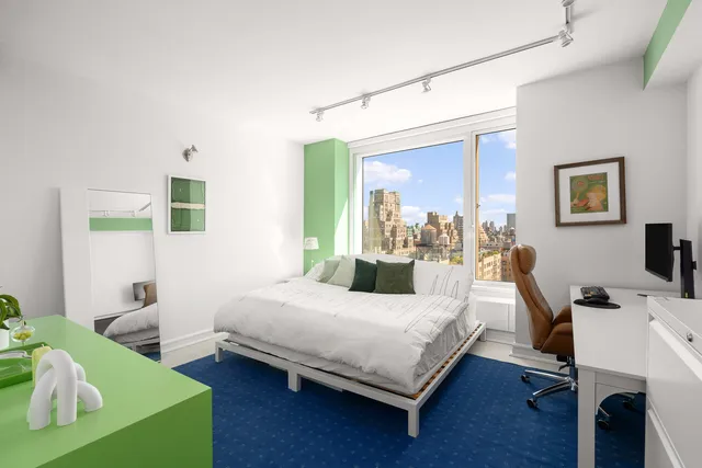 a bedroom with furniture and a large window