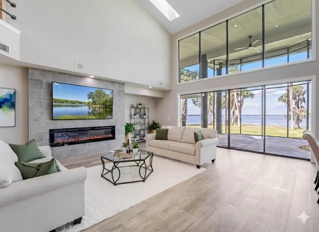 a living room with furniture and a floor to ceiling window