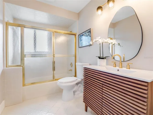 a large bedroom with a bed and a large window