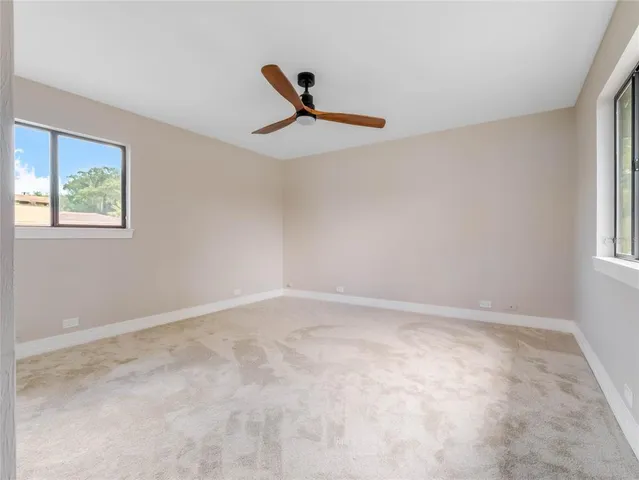 a view of an empty room with windows