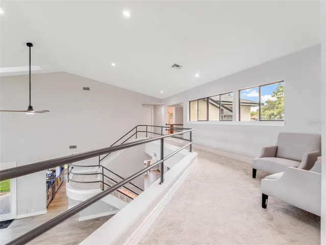 a front view of a house with a yard and potted plants