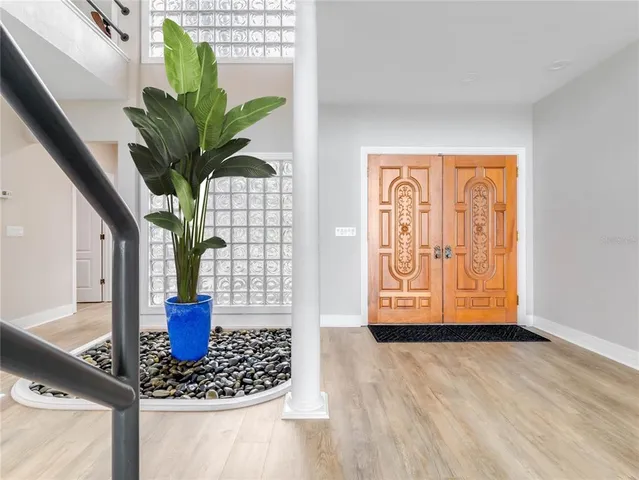 a view of a patio with a dining table chairs and a small yard
