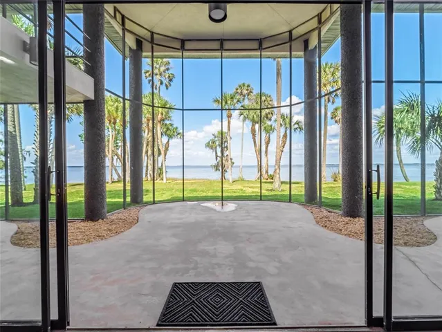 a view of a balcony with chairs and wooden floor