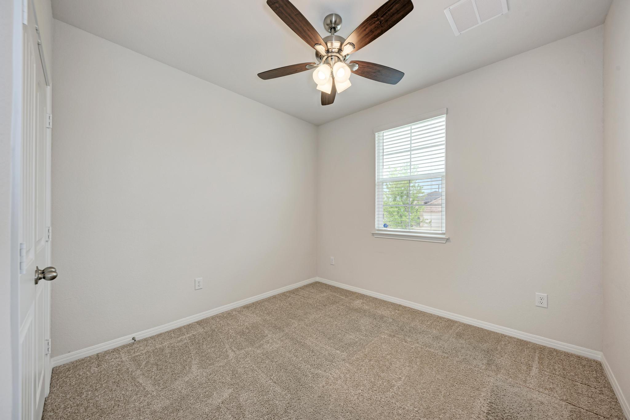 208 Abby Road Georgetown, TX 78626 - Photo 28 of 40 an empty room with a window and a fan