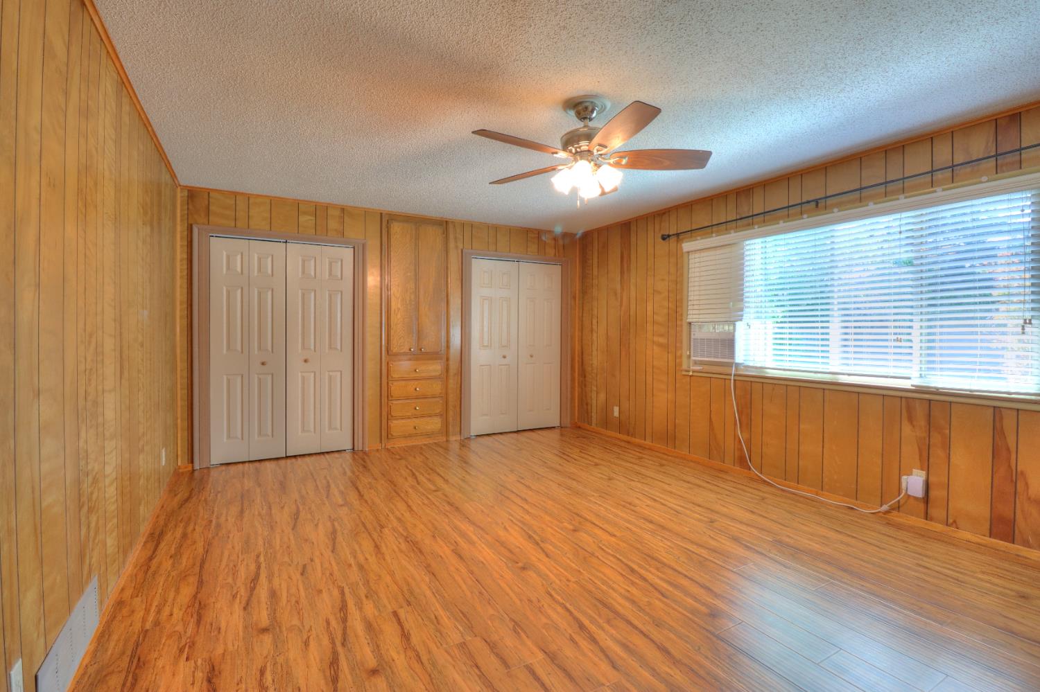6265 North Colonial Avenue Fresno, CA 93704 - Photo 19 of 22 a view of an empty room with wooden floor and a window