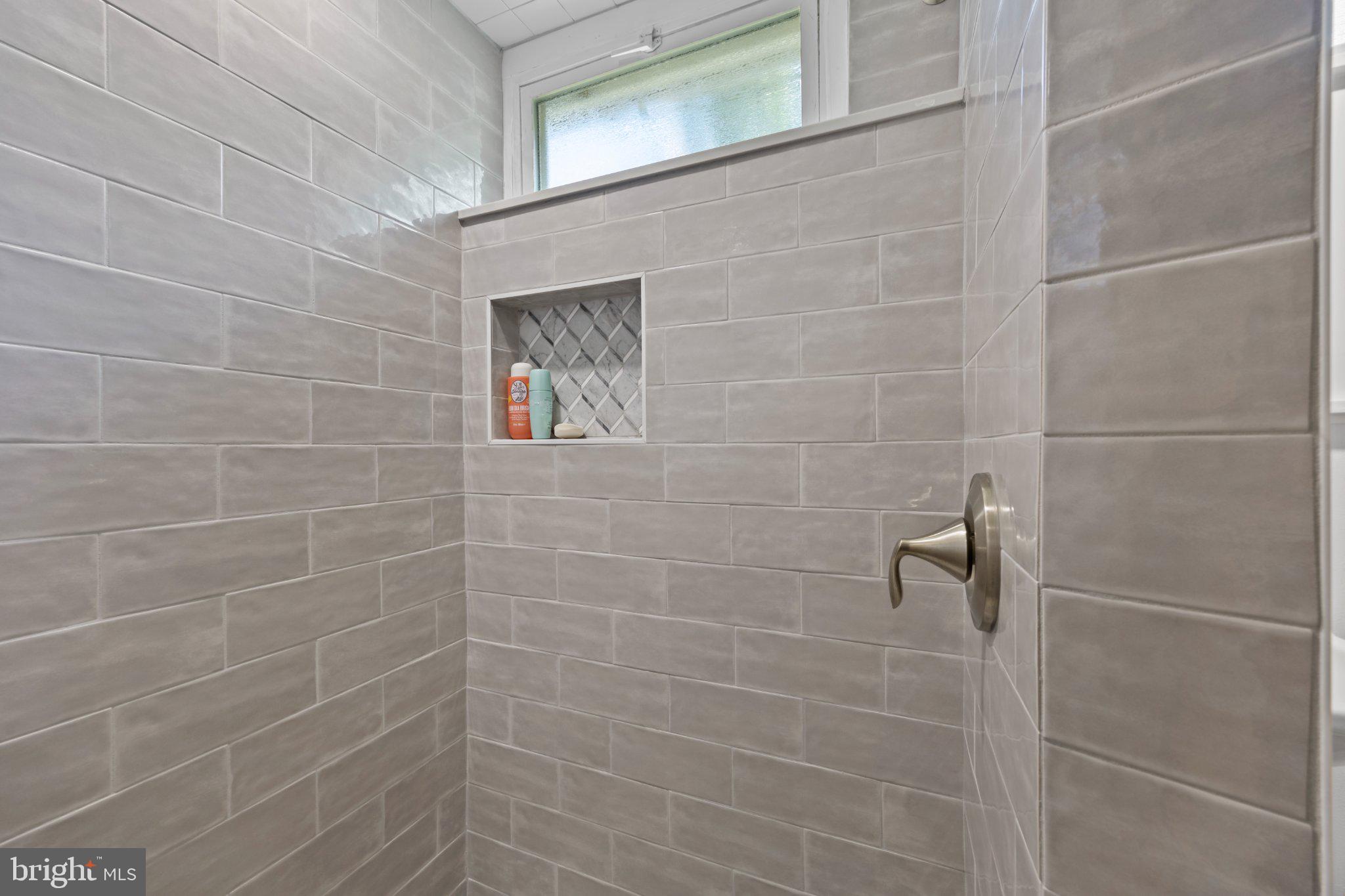 6705 New Hope Drive Springfield, VA 22151 - Photo 50 of 67 Sleek modern shower with elegant tiles.