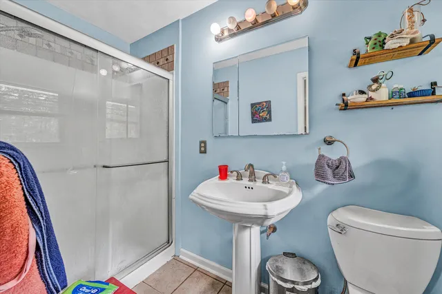 a bathroom with a sink toilet and a mirror
