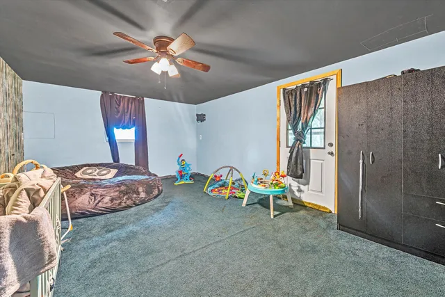 a living room with furniture and chandelier