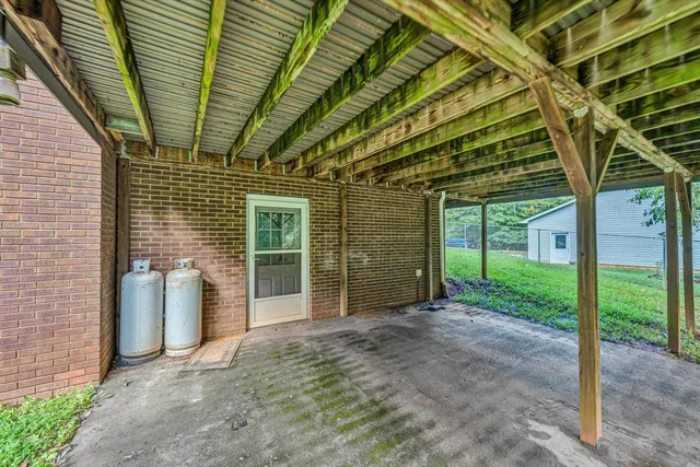 a view of a porch with wooden walls and stairs