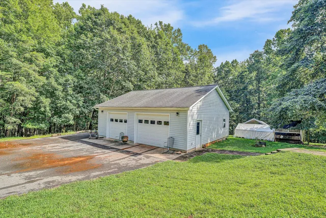 a view of a house with yard and tree s