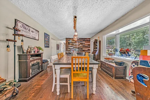 a dining room with furniture and wooden floor