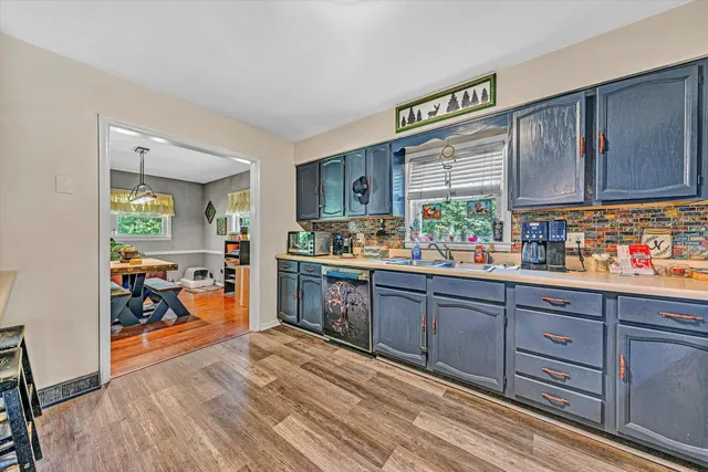 a kitchen with lots of counter top space and wooden floor