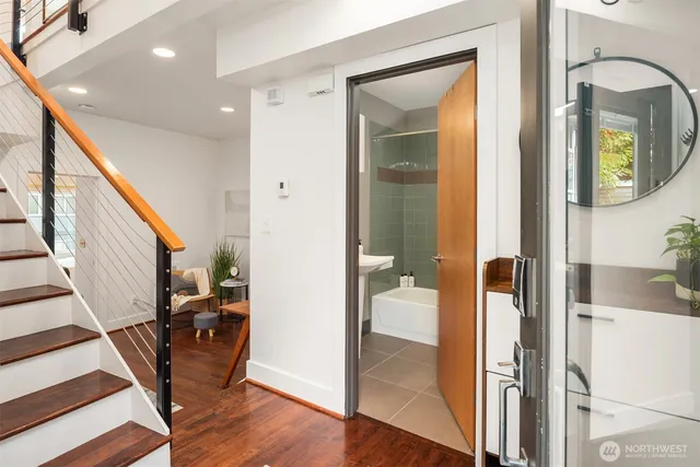 a view of a hallway with wooden floor and staircase