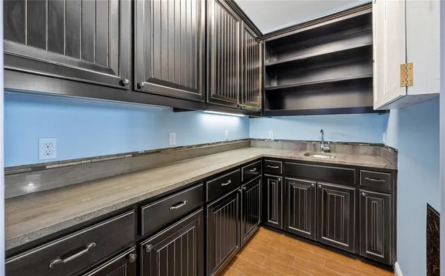 a kitchen with granite countertop cabinets stainless steel appliances and a sink