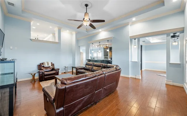 a living room with hard wood flooring and furniture