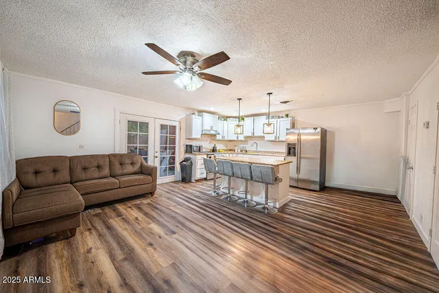 a living room with stainless steel appliances furniture and a rug