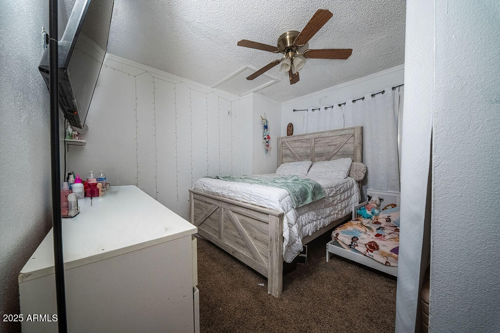4233 North 68th Avenue Phoenix, AZ 85033 - Photo 6 of 11 a bed room with a bed and a chandelier