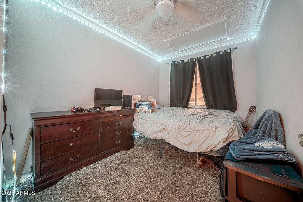 4233 North 68th Avenue Phoenix, AZ 85033 - Photo 8 of 11 a bedroom with a bed and a television