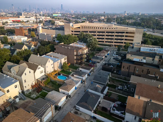 an aerial view of a house with a yard large trees