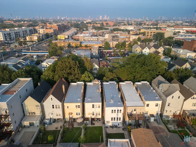 an aerial view of house with yard swimming pool and ocean view
