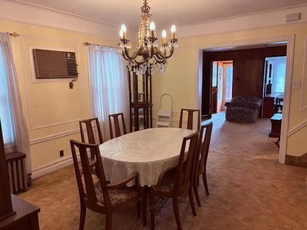 a view of a dining room with furniture and chandelier