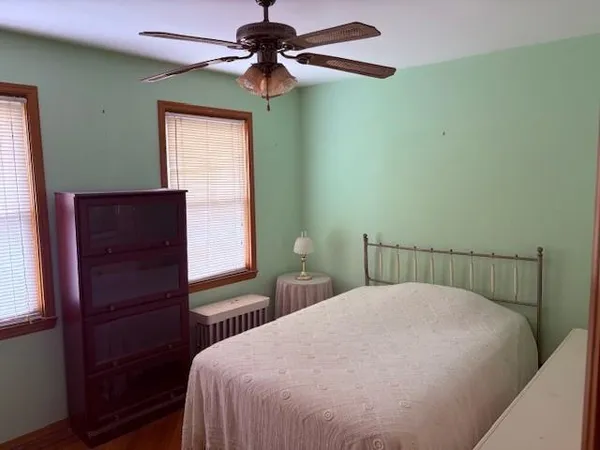 a bedroom with a bed and a window