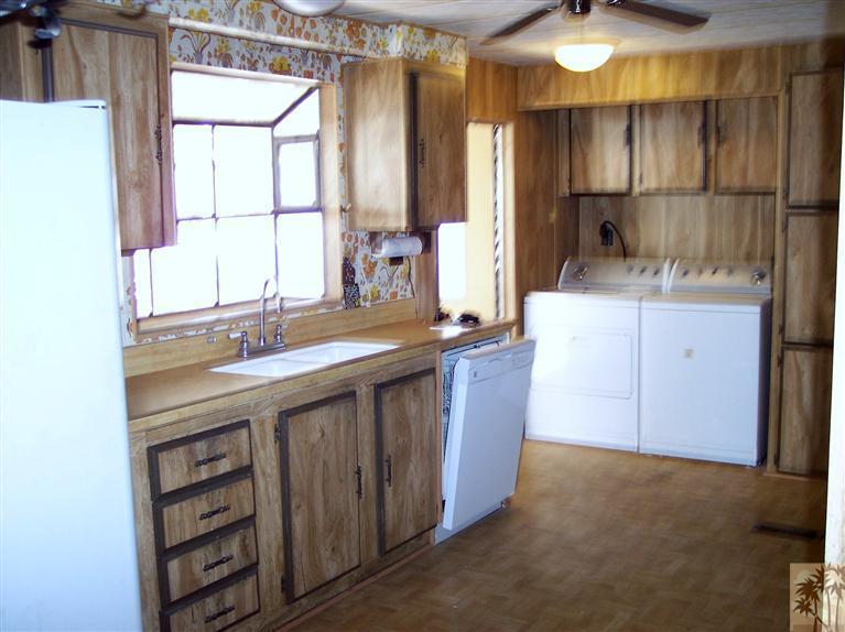 18555 Roberts Road, Unit 36 Desert Hot Springs, CA 92241 - Photo 13 of 20 a kitchen with a sink cabinets and window