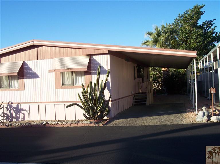 18555 Roberts Road, Unit 36 Desert Hot Springs, CA 92241 - Photo 3 of 20 a front view of a house with garden