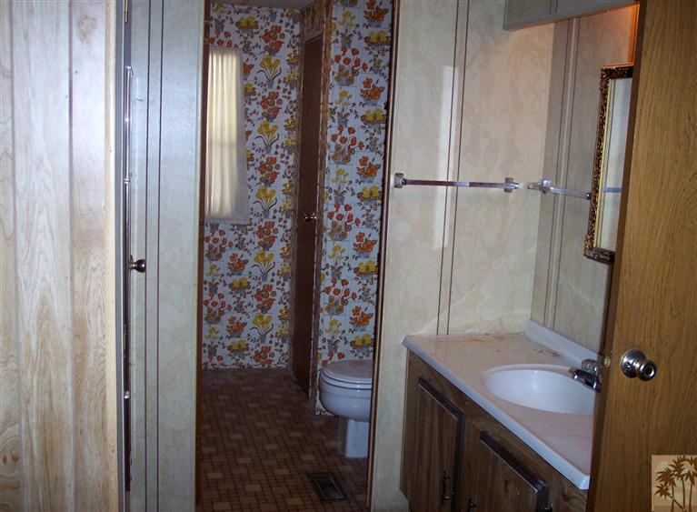 18555 Roberts Road, Unit 36 Desert Hot Springs, CA 92241 - Photo 10 of 20 a bathroom with a granite countertop sink toilet and shower
