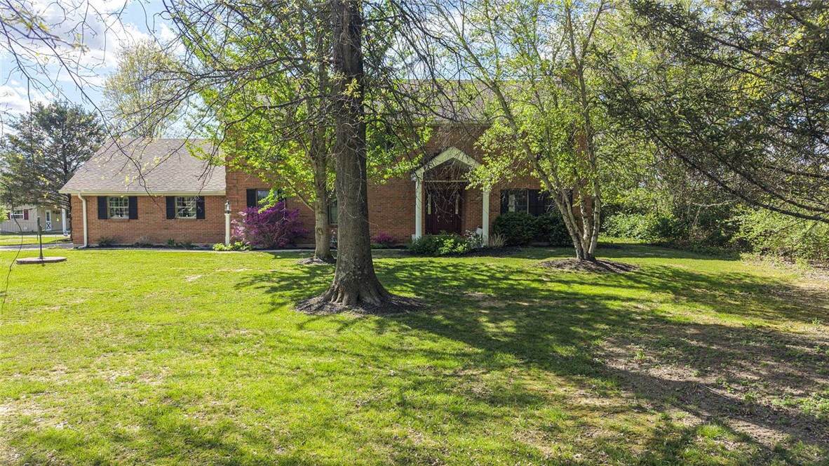 1757 Phillips Road Lebanon, OH 45036 - Photo 3 of 51 This charming brick home is nestled amidst lush greenery, offering a private and serene setting.