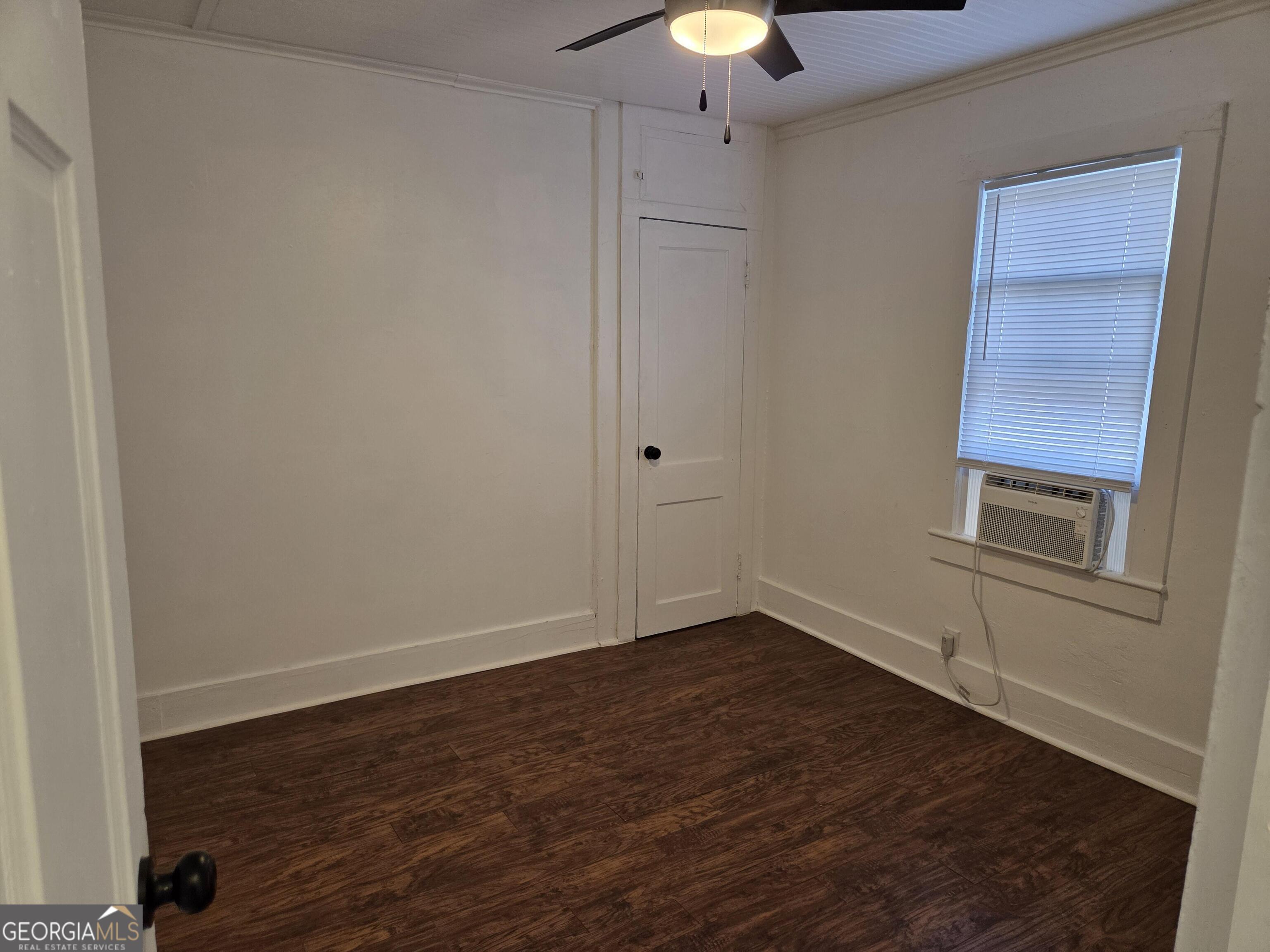 1502 Monck Street Brunswick, GA 31520 - Photo 13 of 32 a view of an empty room with wooden floor and a window