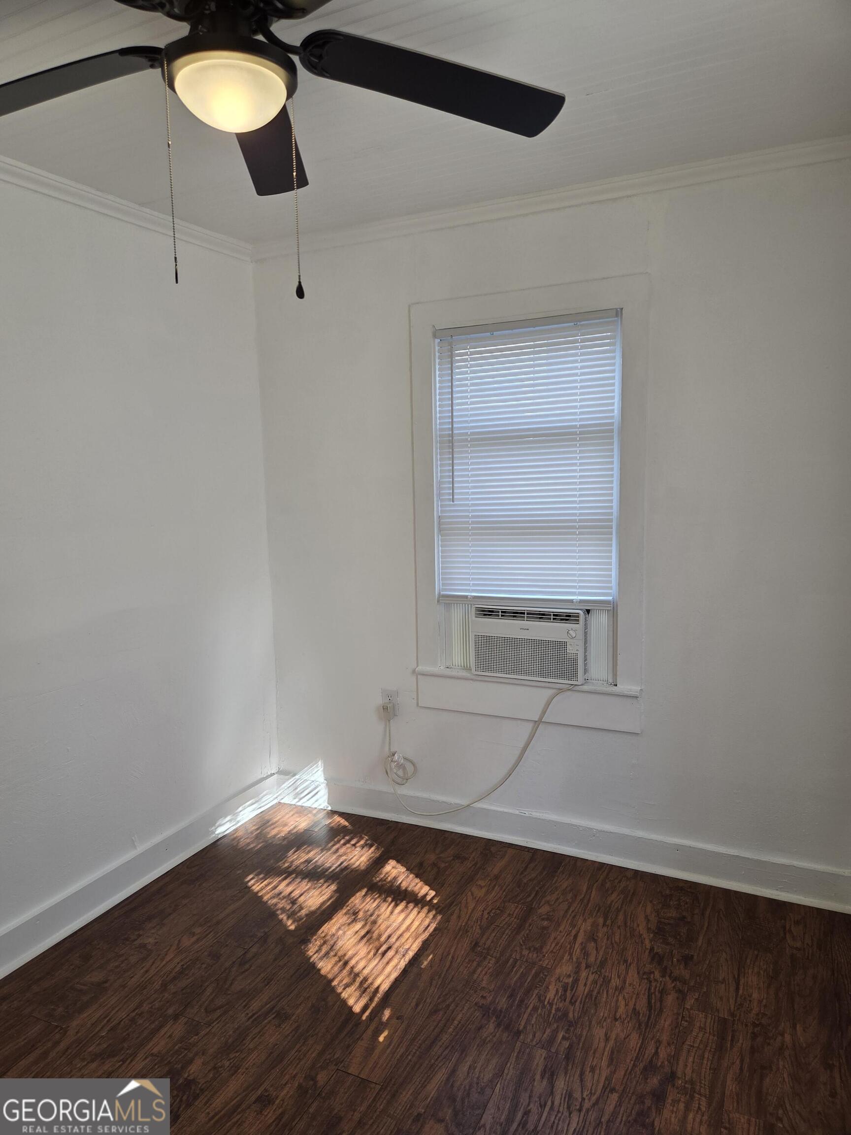 1502 Monck Street Brunswick, GA 31520 - Photo 19 of 32 a view of empty room with wooden floor and fan