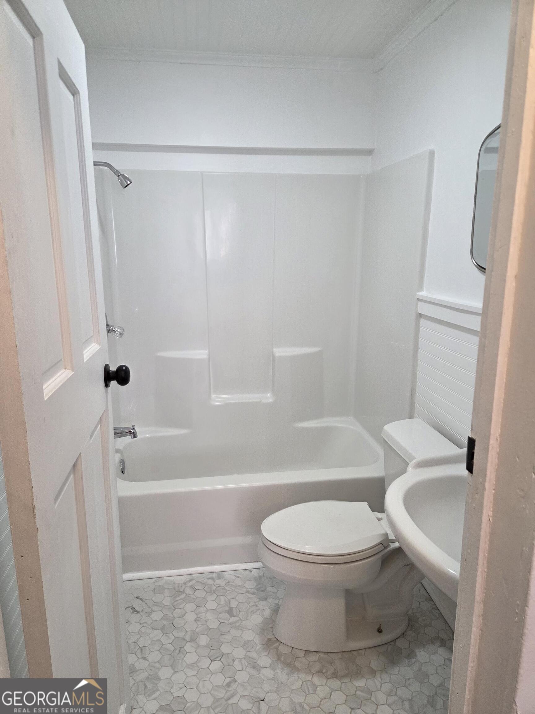 1502 Monck Street Brunswick, GA 31520 - Photo 21 of 32 a white toilet sitting next to a bath tub