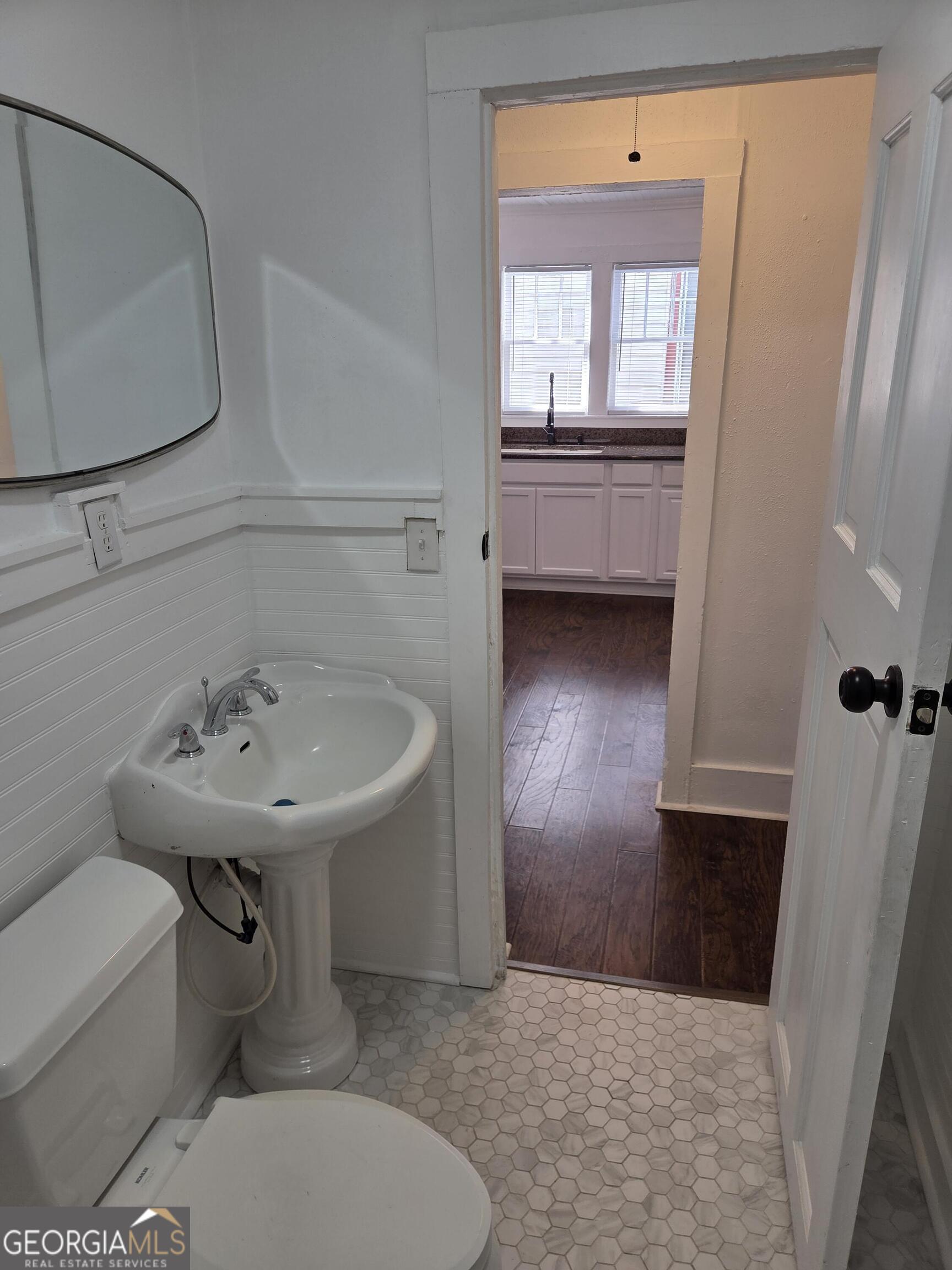 1502 Monck Street Brunswick, GA 31520 - Photo 22 of 32 a bathroom with a sink a toilet and bathtub